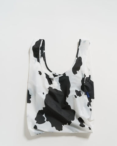 black and white cow standard baggu reusable shopping bag holds up to 50lbs. can fit over shoulder. made from 40% recycled ripstop nylon