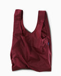 cranberry standard baggu reusable shopping bag holds up to 50lbs. can fit over shoulder. made from 40% recycled ripstop nylon